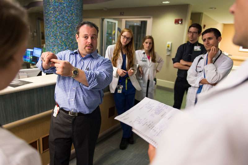 Medical student listen to their teacher intently in a clinical setting