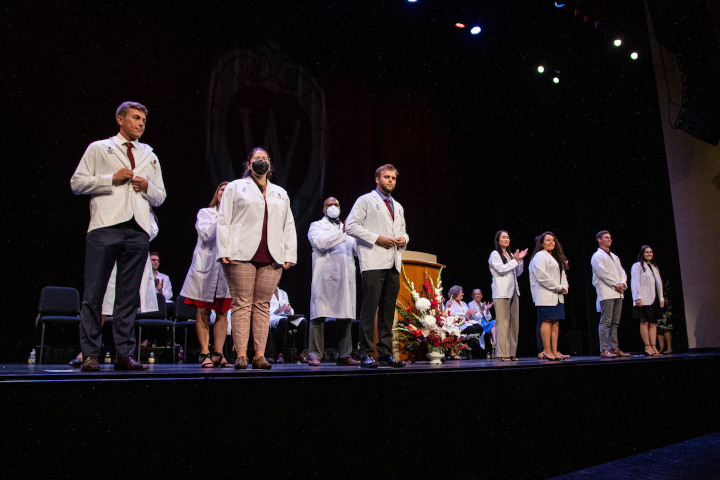 Incoming students don their first white coats