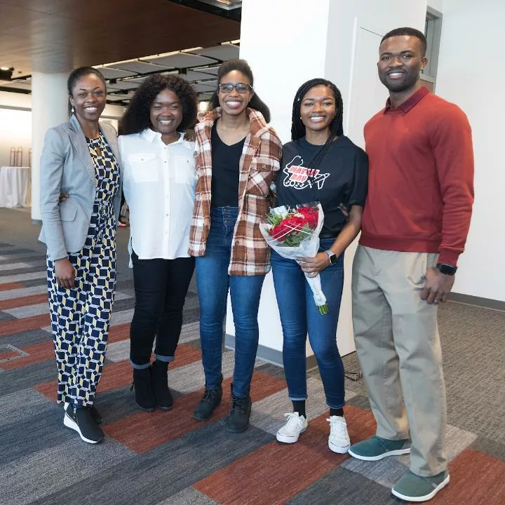 Sharon Rose Nartey standing with her family