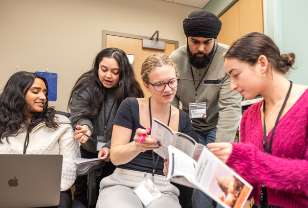 Student volunteers discuss pamphlets and notes