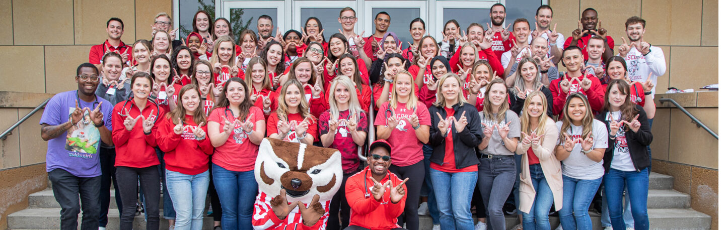 A large group of students smiling and repping UW–Madison