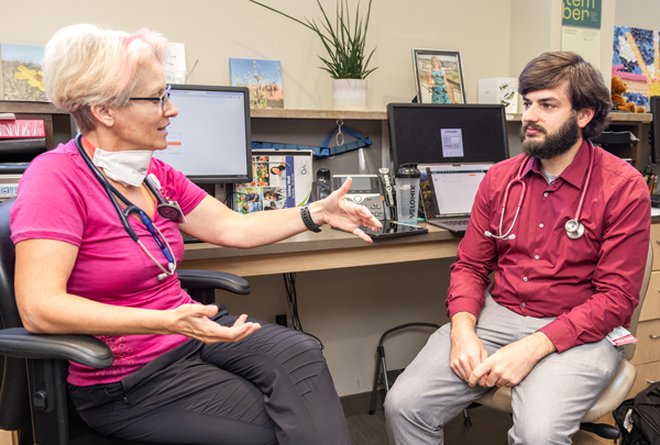 Dr. Danalyn Rayner talks with medical student Ethan Richmond