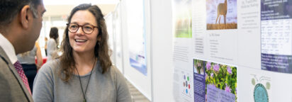 Two people enjoying a discussion at a research poster session