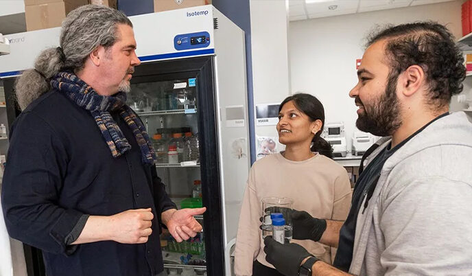 Chapman and researcher in the lab