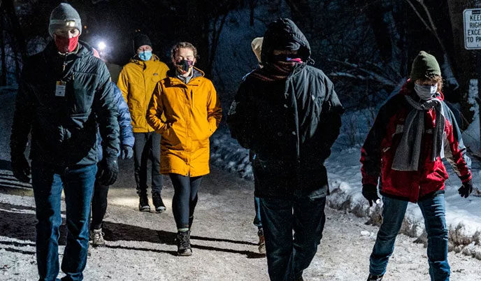 A group of pedestrians wearing masks