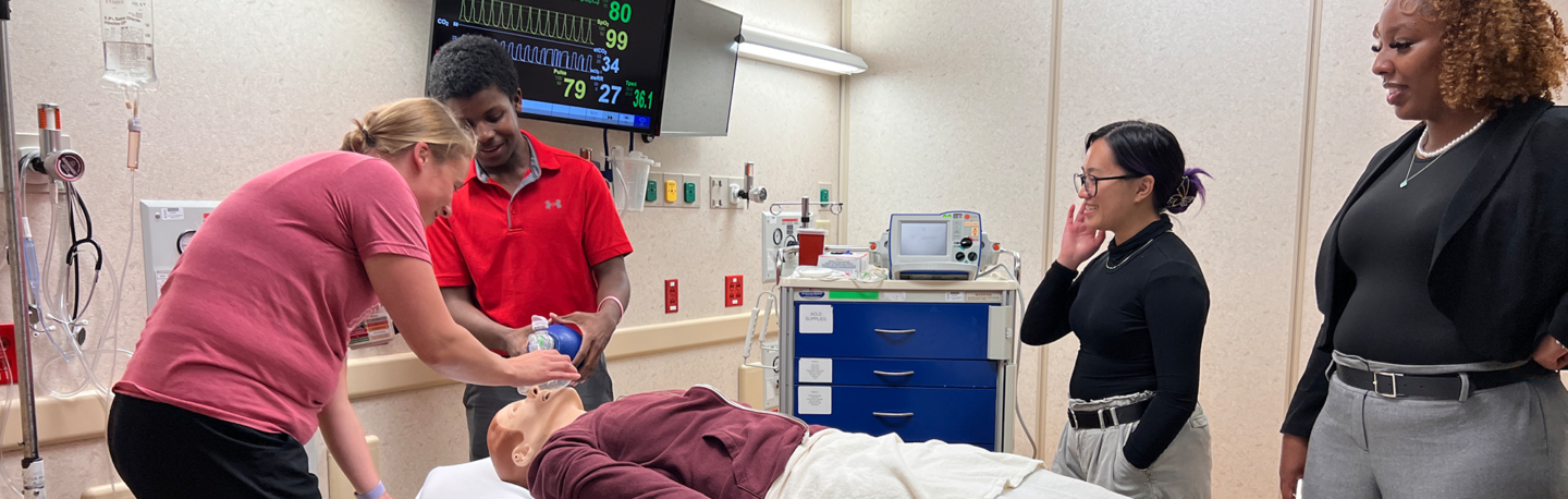 RUSCH students practice using a ventilator on a medical mannequin