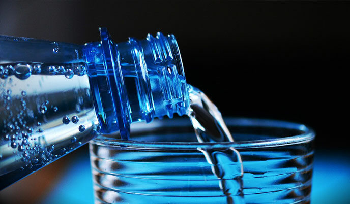 water bottle pouring into a glass