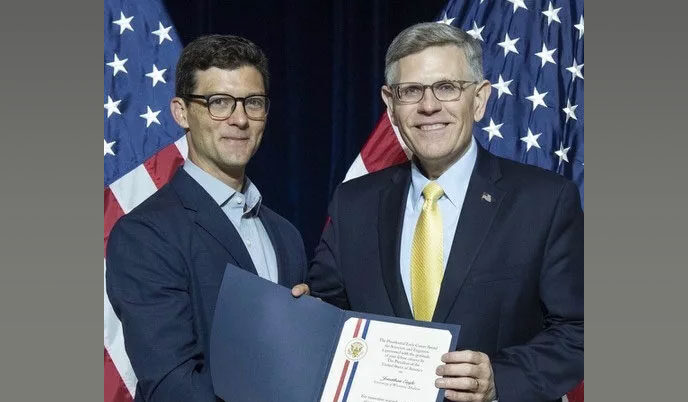 Jonathan Engle receiving an award