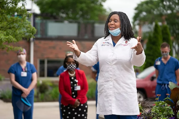 A doctor greets new medical students