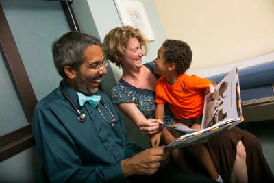 A doctor reads to a child