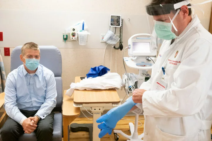 A man waits to receive a vaccine