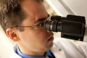 Mark Burkard looking into a microscope