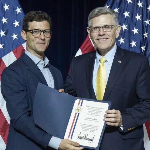 Jonathan Engle receiving an award