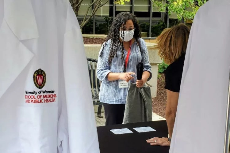 A student receives a white coat